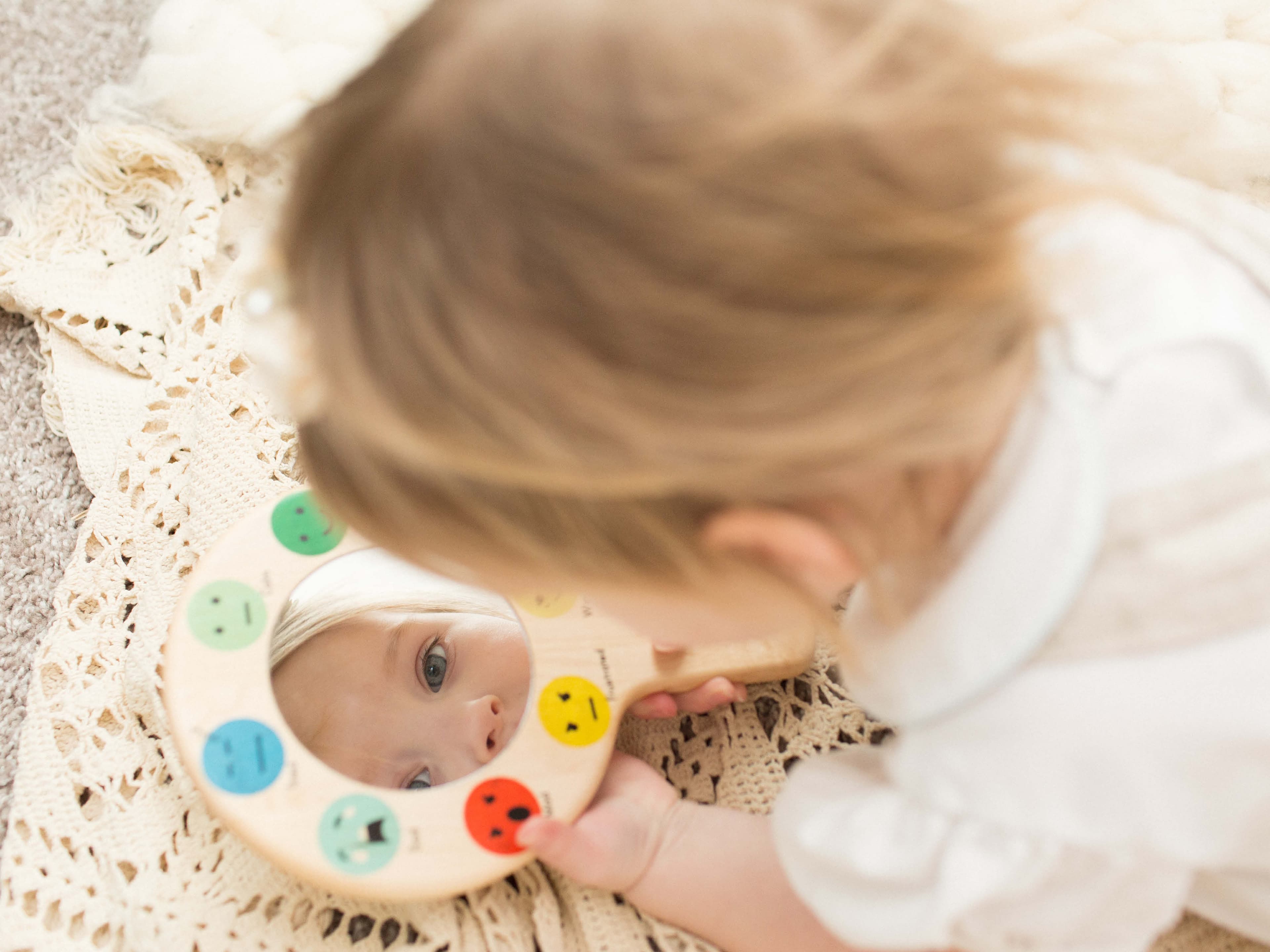 Little girl with a mirror